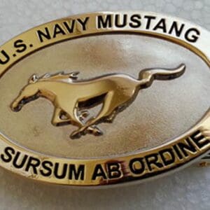 A belt buckle with the u. S. Navy mustang logo on it