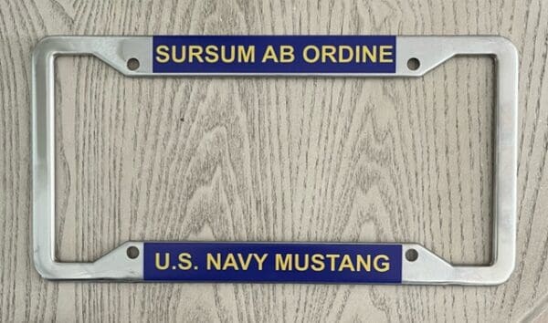 A pair of blue and yellow nameplates on a wooden wall.