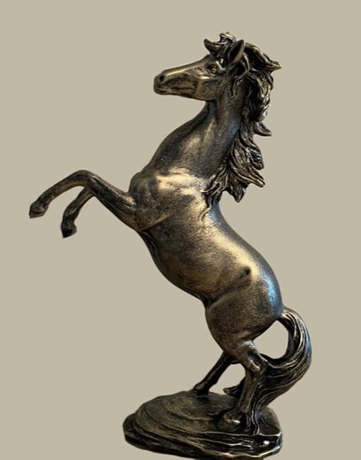 A horse statue is shown in bronze.