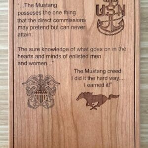 Wooden plaque with Navy and Mustang engravings.