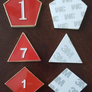 A set of six red and white pins.