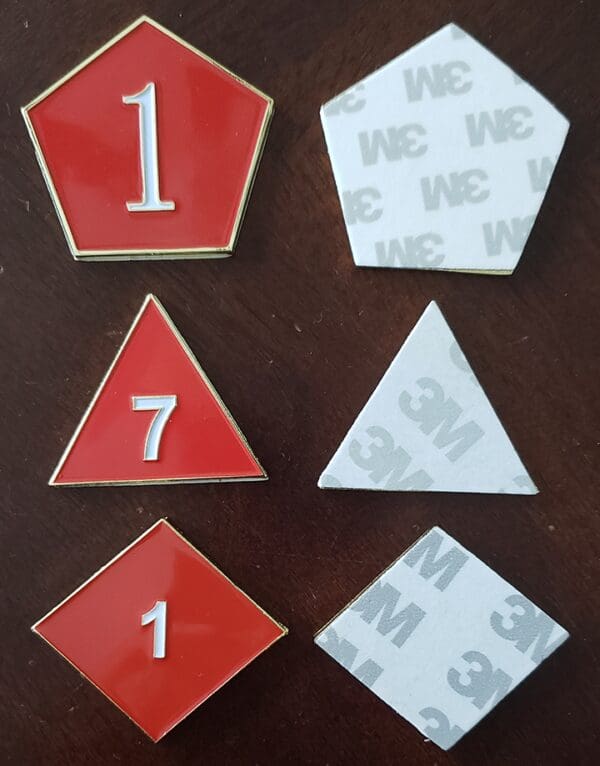 A set of six red and white pins.