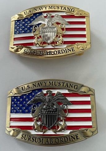 Two american flag belt buckles with a gold eagle and the words " united states marine corps " on them.