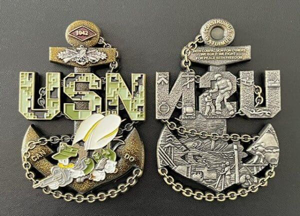 A pair of medals with the words usn military on them.